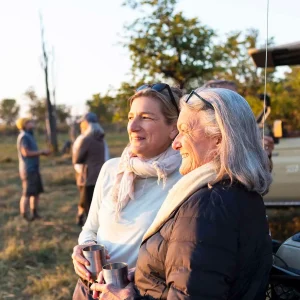 senior woman and adult daughter on safari, Okavango Delta, Botswana