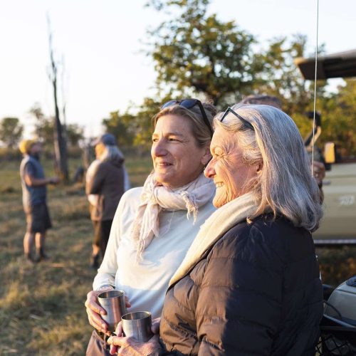 senior woman and adult daughter on safari, Okavango Delta, Botswana