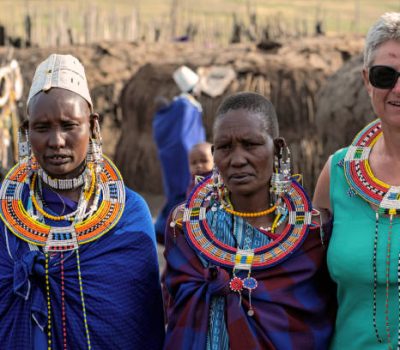 Serengeti, Tanzania - March 12, 2015: Masai with traditional ornaments and tourist review of daily life of local people on March 12, 2015 near Serengeti National Park.