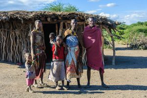 Lake Eyasi, Tanzania - May 29, 2015: A Datoga family in front of their home at Lake Eyasi, Tanzania